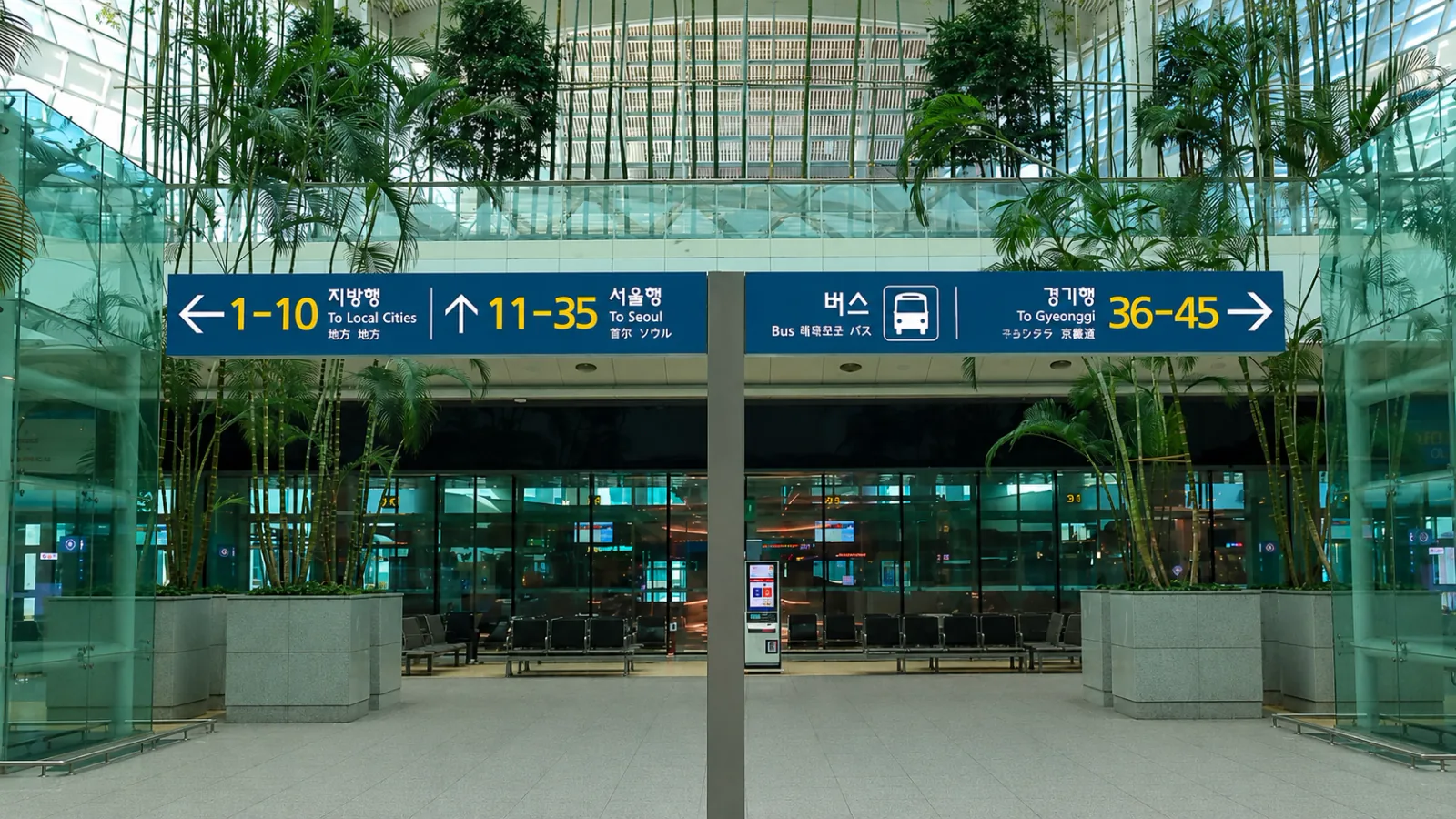 Terminal 2 signs for local-city, Seoul and Gyeonggi airport bus boarding areas at Incheon Airport