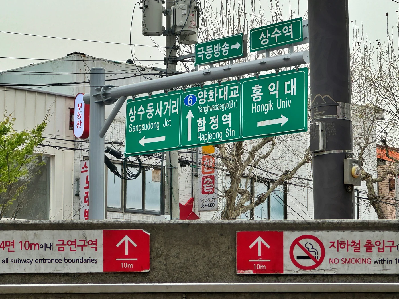 Señales de carretera hacia Sangsu-dong, Hapjeong Station y Hongik University
