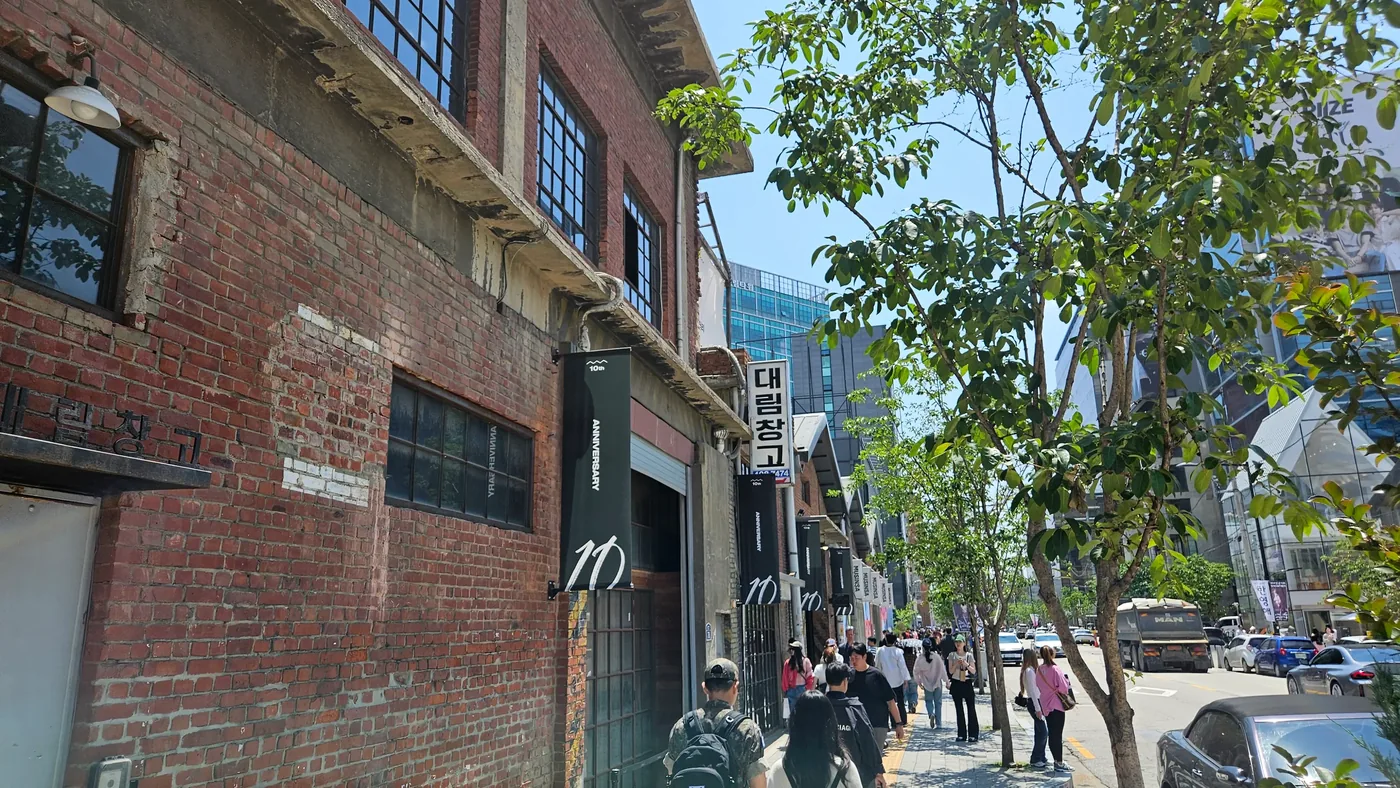 Brick industrial building beside a busy modern street in Seongsu, Seoul.